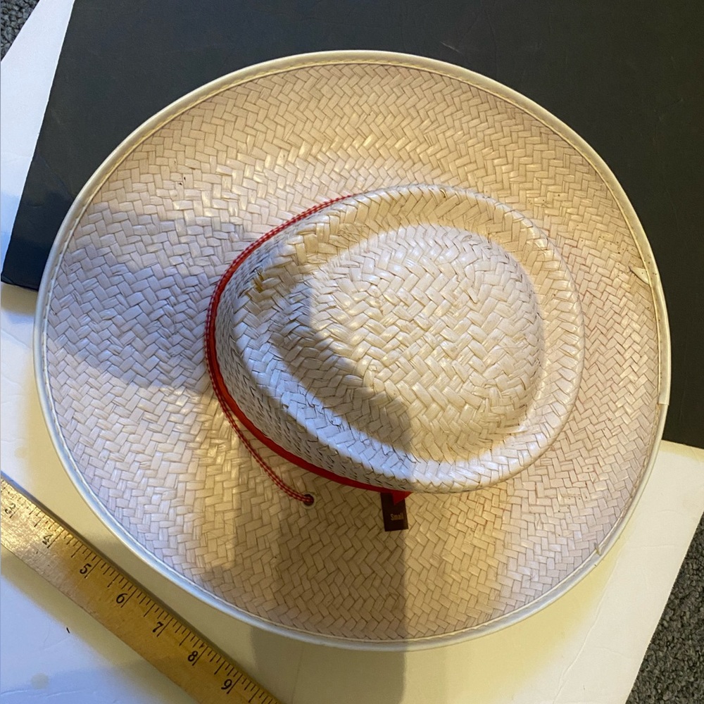 Small painted white hat with red string